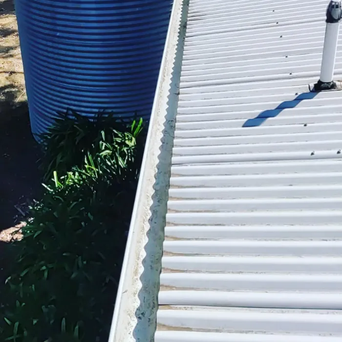 Clean gutter beside a rainwater tank