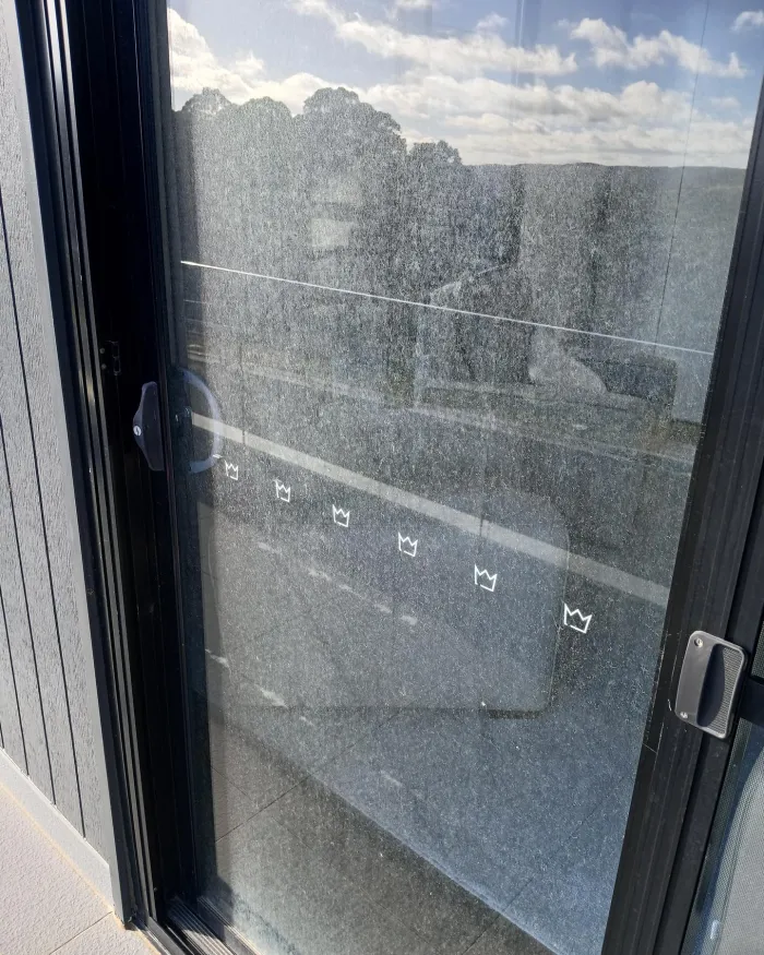 Sliding glass door covered in grime and water spots